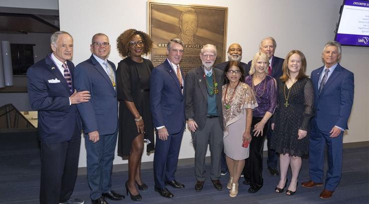 Group posing and honoring McDowell plaque.